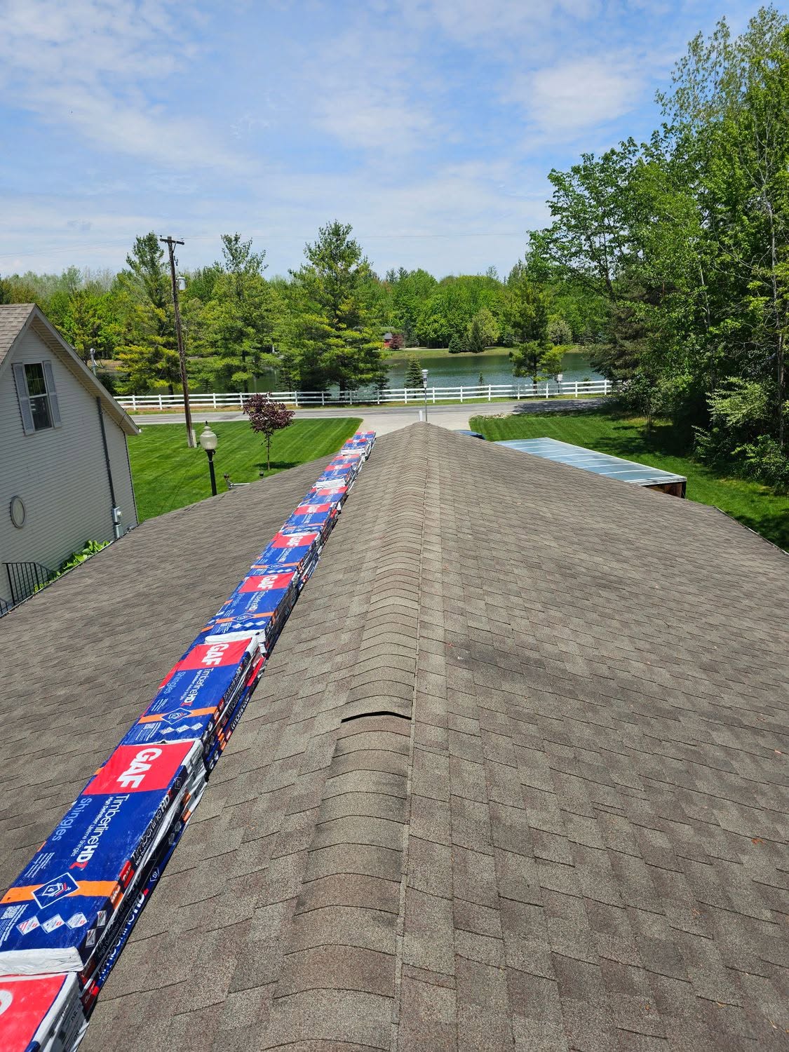Roofing materials staged on a residential roof